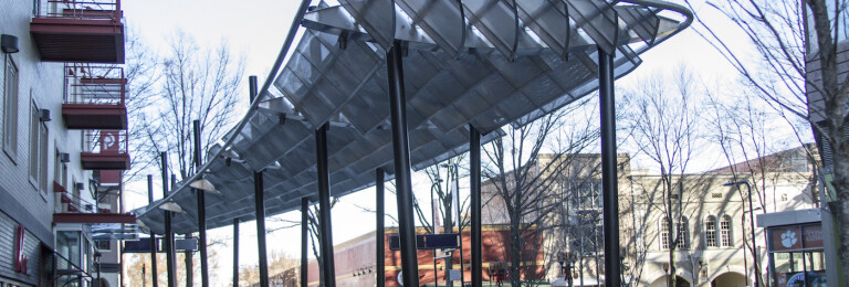 Banker Wire mesh forms a shade structure that serves as the centerpiece for the plaza, and meaningfully evokes Greenville’s history.
