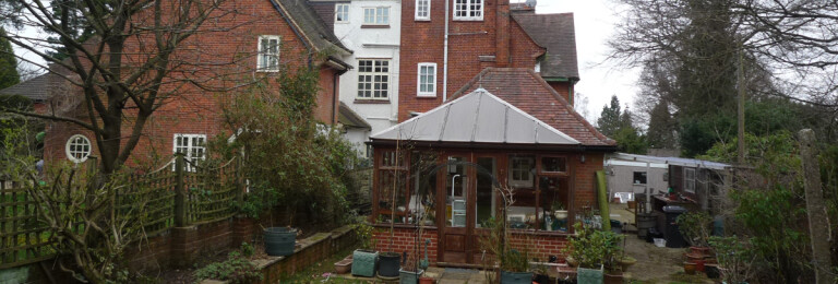 Back garden crowded with multiple rear extensions at a1900s family home