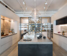 The opposing brick and marble textures in the kitchen create a strong balance in the space.