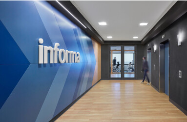 In the elevator lobby a directional graphic in Informa’s brand colours directs guests to the reception area.