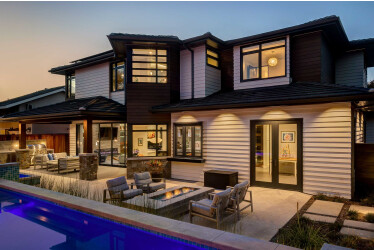 The contemporary-meets-Craftsman design features an attractive outdoor living space.