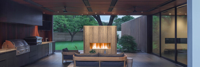 The J Series M1 Outdoor Fireplace by European Home acts as a focal point to this luxurious outdoor room.