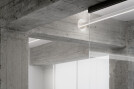 A lighting element traverses the concrete beam.