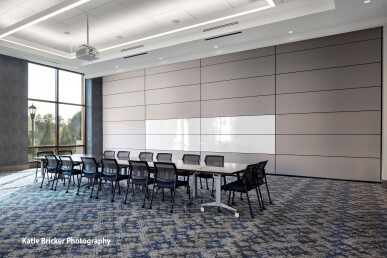 Skyfold movable wall sub-dividing an office boardroom