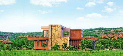 Merging with the Context: Wall cladding designed to resonate with the background of quarried rock on the Aravali Range.