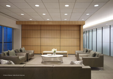 Skyfold Classic movable wall in a wood veneer finish sub-dividing a reception area from a boardroom