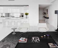 KITCHEN AND LIVING ROOM: Glossy Polyester Lacquer with stainless stell blacksplash kitchen by Boffi; Corian kitchen island custom designed by Giusi Mastro;  B&B Italia sofa; Kasthall carpet; lamp by Flos; coffee table by B&B Italia; flooring by LV Wood