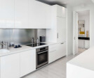 KITCHEN by Boffi: glossy polyester lacquer cabinets; counters in Corian; backsplash in stainless steel. Flooring by LV Wood.