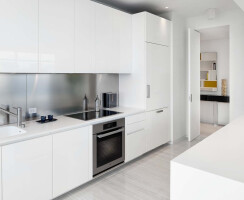 KITCHEN by Boffi: glossy polyester lacquer cabinets; counters in Corian; backsplash in stainless steel. Flooring by LV Wood.