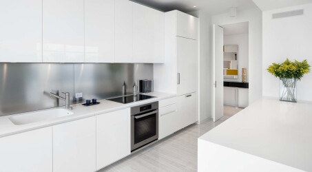 KITCHEN by Boffi: glossy polyester lacquer cabinets; counters in Corian; backsplash in stainless steel. Flooring by LV Wood.