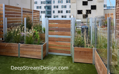 Large Glass and Wood Screen Wall Enclosure anchored by Commercial Planters with Gates create a Roof Deck Dog Park with out penetrations