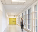 Hallways are filled with large windows, allowing for ample natural lighting.