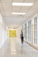 Hallways are filled with large windows, allowing for ample natural lighting.