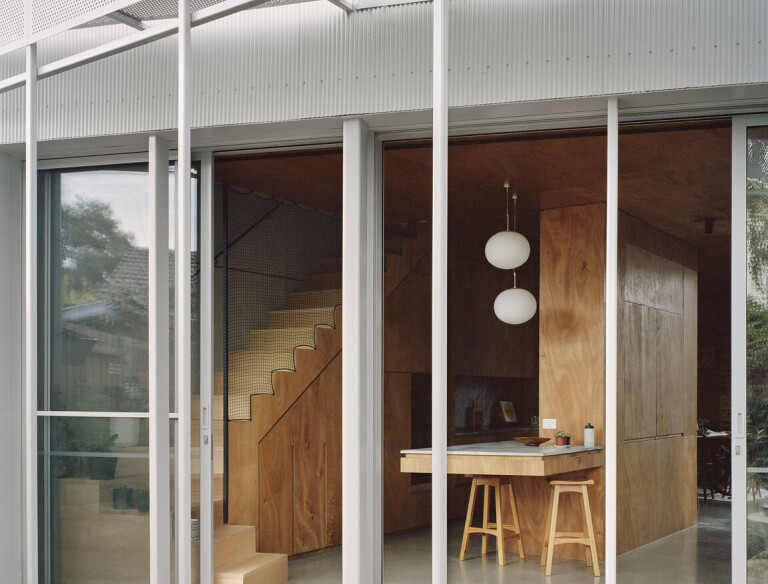 Perforated steel sunshading along the length of the rear verandah provides sun control in summer while still allowing passive heat gain in winter.