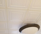 The Stratford panel has a shallow coffered design that gives the ceiling scale and and style. The fine perforations improve its acoustics. Even with glancing sidelight, the thin thermoformed panels lay flat in the suspended ceiling grid.