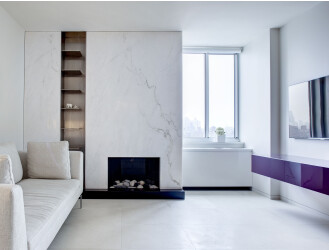 READING ROOM: Charles sofa by B&B Italia; fireplace in marble by BAS Stone; stainless steel shelves by Total Metal Resource; stainless steel custom sculpture by Giusi Mastro; purple cabinet by Poliform.