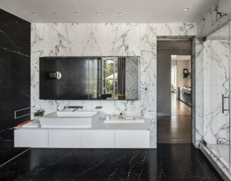 MASTER BATHROOM – flooring and wall marble by Antolini ; shower system, sink, vanity, mirror by Boffi; lighting by iGuzzini.