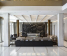 LIVING ROOM - Fireplace in Serpeggiante Kenya marble by Antolini. Octagonal columns and fireplace base in bronze by Extravega; firebox by Mazzola. Coffered ceiling: custom designed; sofa by Fendi.