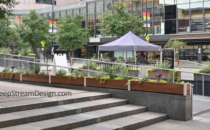 Extra Long Planters create a Parapet Wall along a ramp in an urban park to deter skateboarders