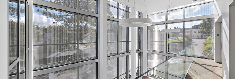 Transparent wire mesh elements filter sunrays and provide a comfortably fresh and at the same time light indoor climate