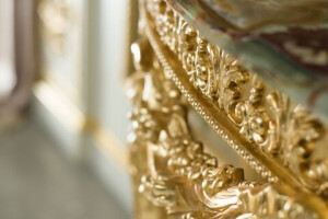 ARTISANAL EMPIRE CONSOLE IN GOLD LEAF WITH ONYX TOP AND HANDMADE CARVINGS