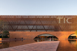 TIC Art Center by DOMANI Architectural Concepts showcases a mesh-like building façade set in a dramatic landscape