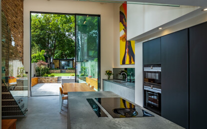 Tall sliding door solutions in modern kitchen extension.