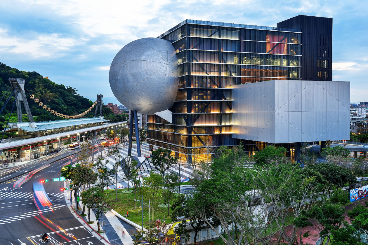 OMA inverts theater typology by plugging three cantilevered theaters into a central cube