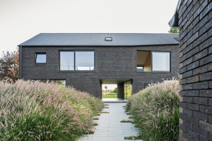 Habitat Groupé Bolette accommodates two separate houses within one confident brick volume