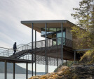 The structure acts as a kind of observation platform for the water and island views beyond.