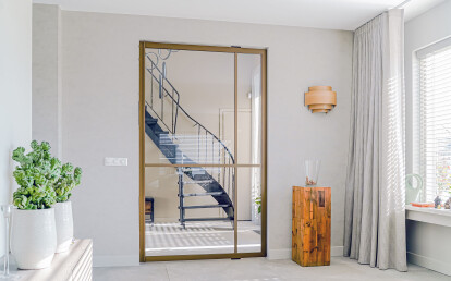 Glass pivot door with bronze anodised aluminium