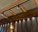 Banker Wire M22-83 Brass wire mesh installed as ceiling tile and TXZ-3 Braided Brass wire mesh installed as wall decor for Beirut Café in Stockholm Sweden