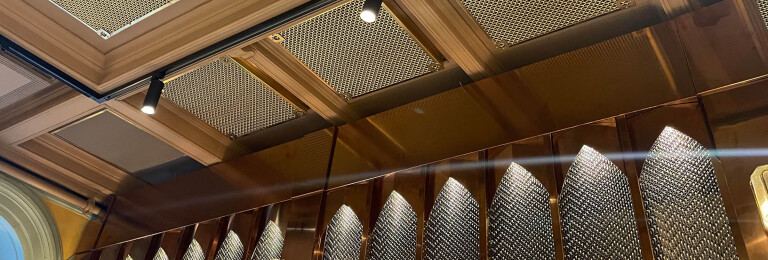 Banker Wire M22-83 Brass wire mesh installed as ceiling tile and TXZ-3 Braided Brass wire mesh installed as wall decor for Beirut Café in Stockholm Sweden