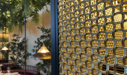 Banker Wire M22-83 Brass wire mesh installed as ceiling tile and TXZ-3 Braided Brass wire mesh installed as wall decor for Beirut Café in Stockholm Sweden