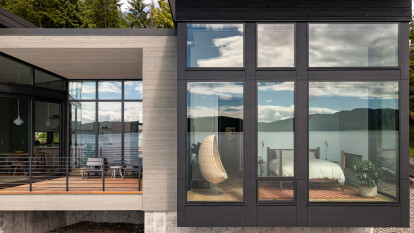 While the landward side of the house has fewer openings to create privacy, the seaward side uses floor-to-ceiling glazing to emphasize living on the water.
