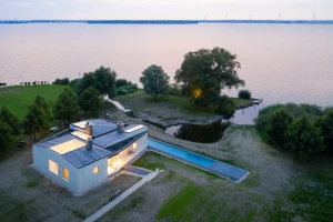 Detail: board-marked concrete walls and timber-clad roof create a refined house on the Raboes