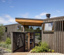 Board and batten cedar siding takes a note from the agrarian region.