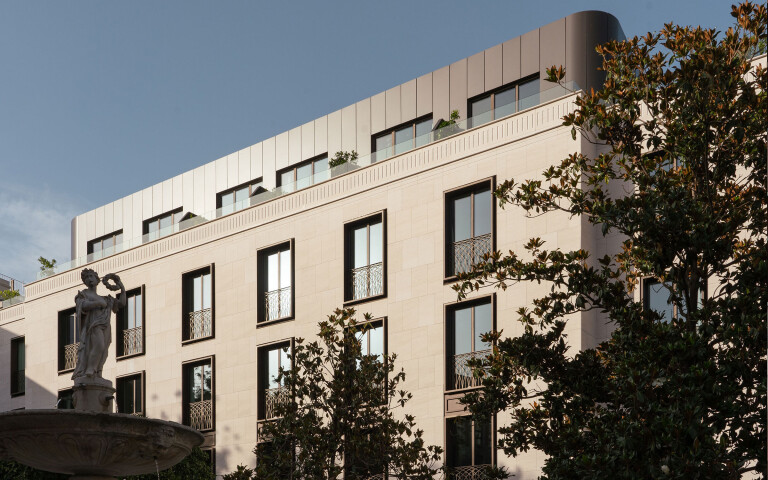 Dignified and atemporal, contemporary facade with precision-cut aluminiom balustrades, developed with a local firm manufacturing plane parts.