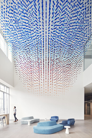 The porous installation breaks the triple-height lobby into a thousand different interstitial spaces, creating a more immersive experience for visitors.