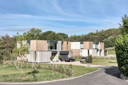 At the front the houses appear as modest 2-storey houses