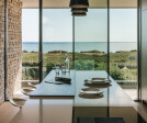 The kitchen opens out onto a terrace overlooking the sea