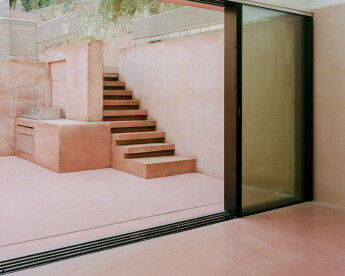 Dusty pink pigmented concrete defines the characterful terraced landscape of Pigment House
