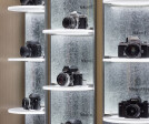 “floating” self-lit acrylic shelves  within galvanized steel curved shafts