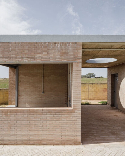 Load-bearing brick walls and geometric folds wrap up this soccer field facility in Seville