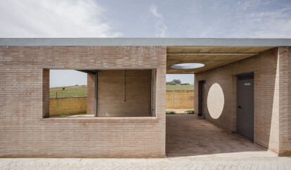 Load-bearing brick walls and geometric folds wrap up this soccer field facility in Seville