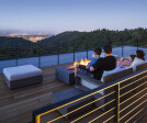 The rooftop deck offers views of Forest Park, the city, and mountains beyond.