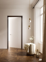 Splayed door frame for flush-to-wall swing door