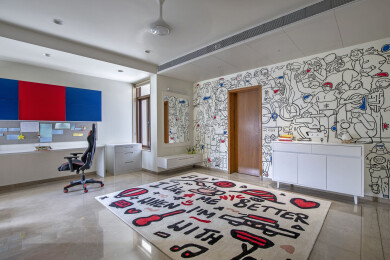 The material palette of the children’s room takes an interesting turn as it consists of a hand-painted wall mural, an artistic rug, and a colourful study corner.
