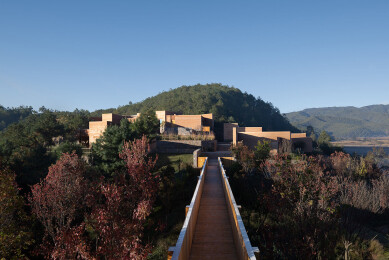 View from public facilities across bridge to visitor dwellings and small event facilities on west ridge