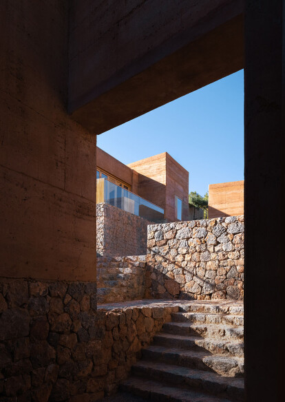 View of stone plinth community infrastructure navigating complex existing topography